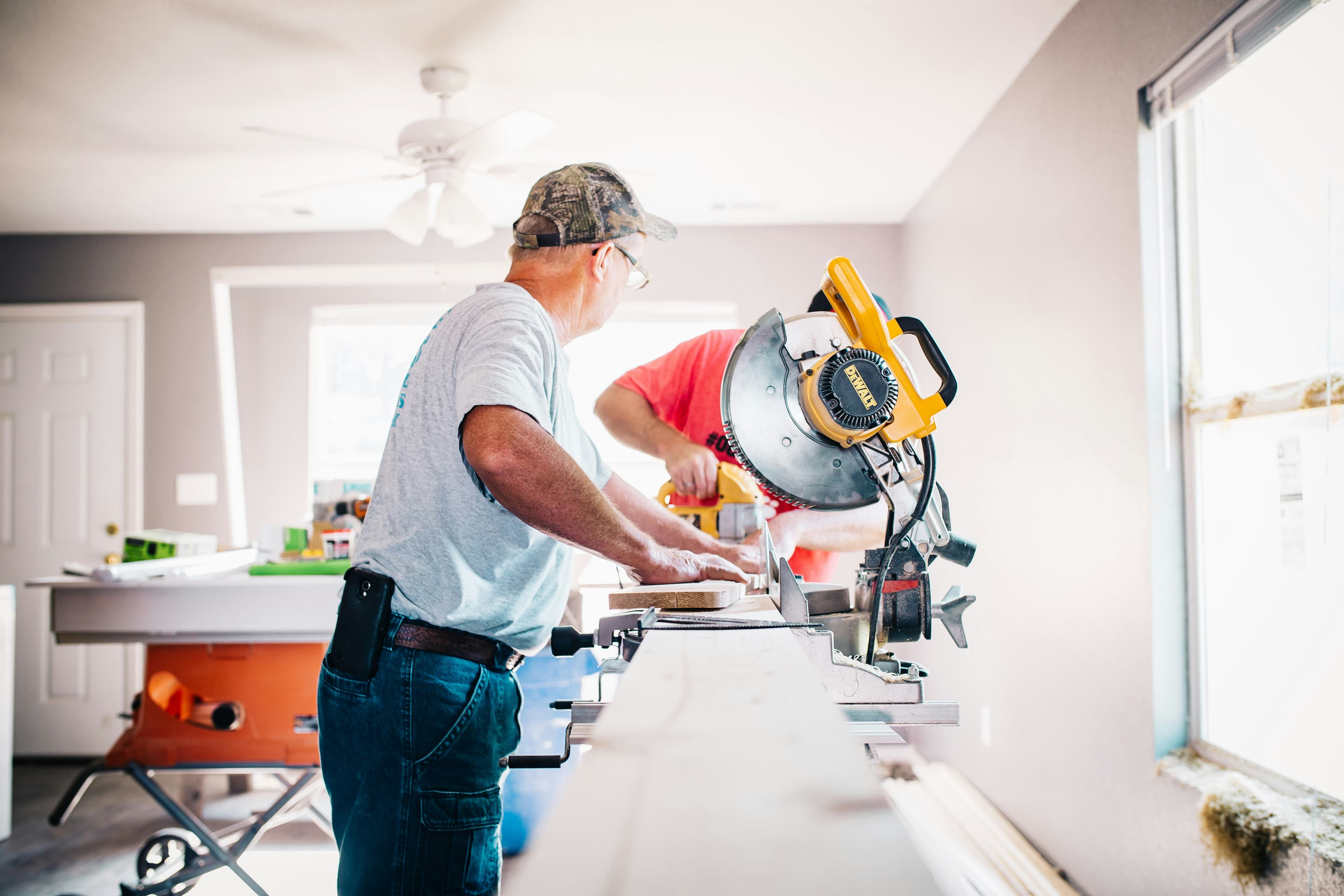 Contractor carefully cutting wood on a job site