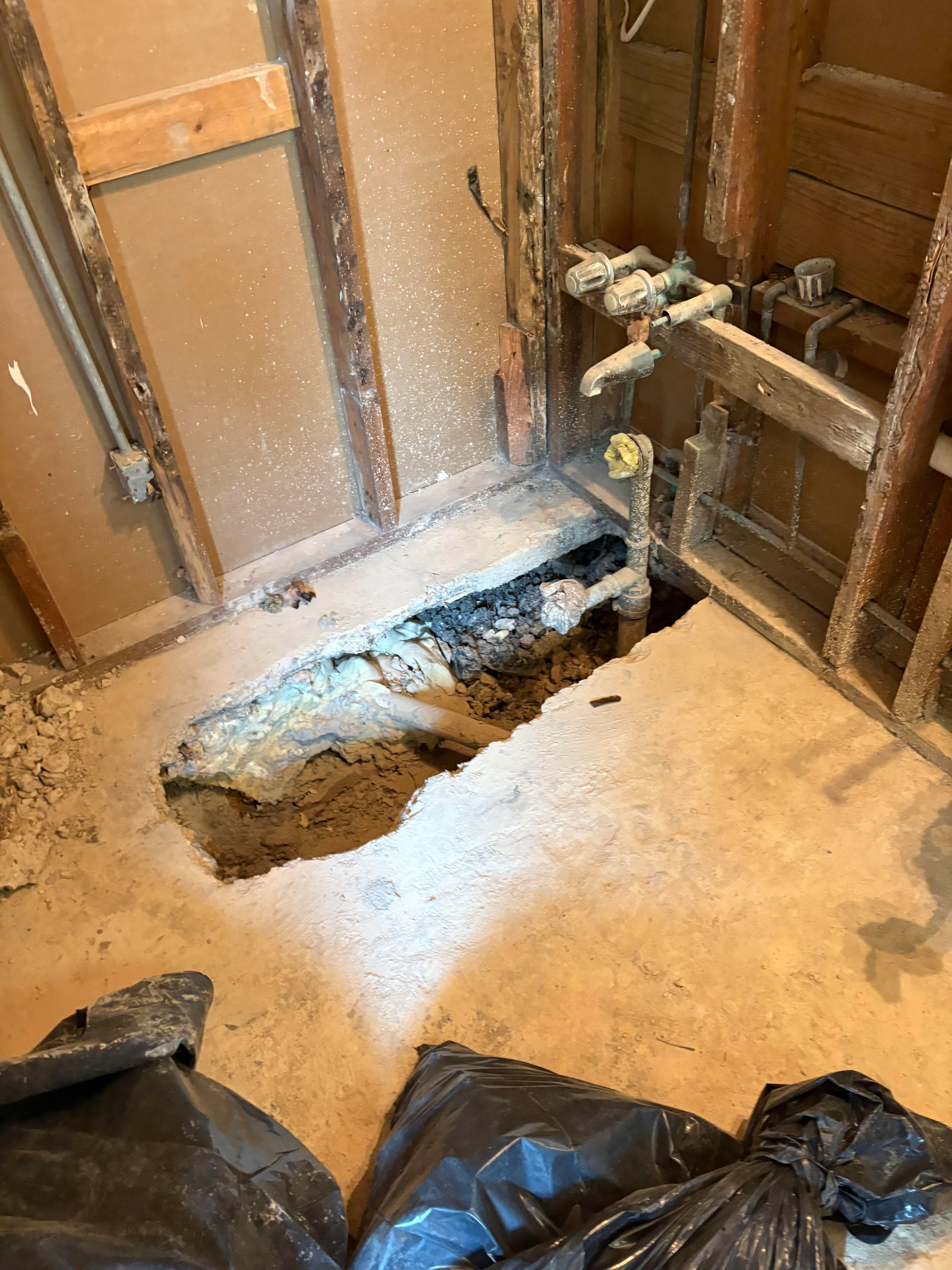 Exposed walls and open floor showing what was found during the remodel